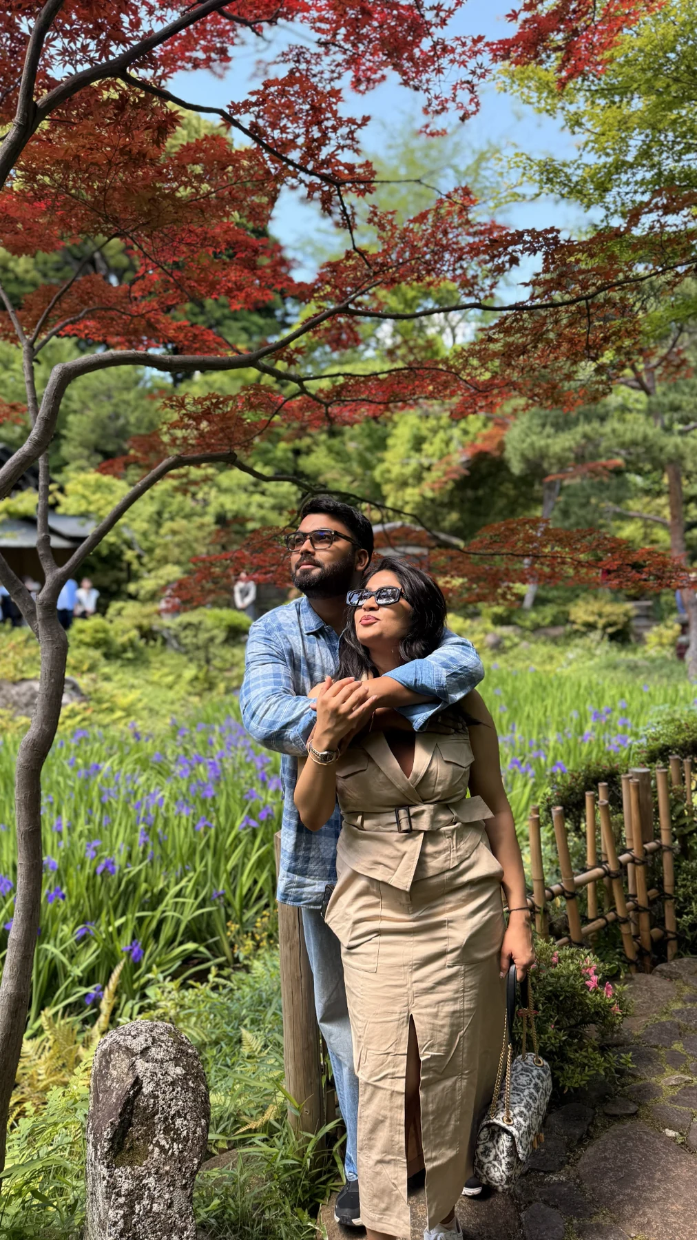 A garden moment beneath red maple leaves